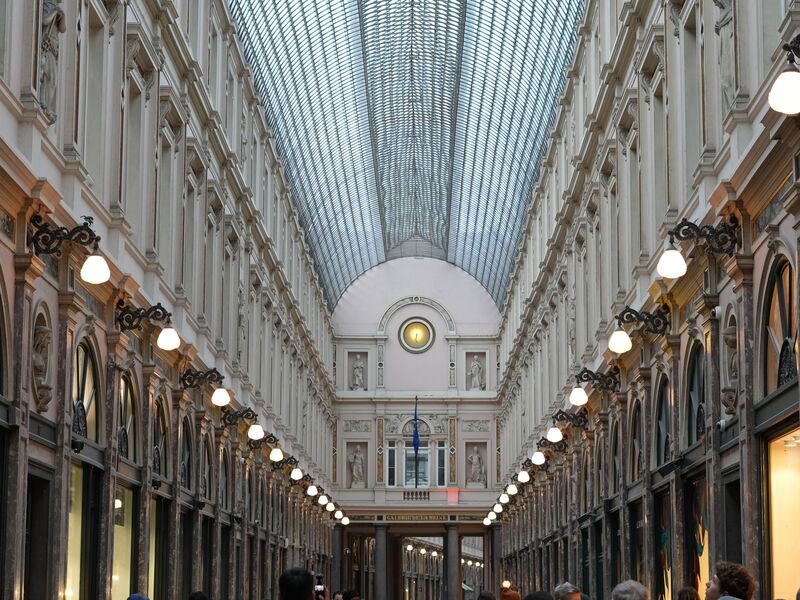 The glazed barrel-vaulted roof and lamp-lit arcade of the Galeries Royales Saint-Hubert in Brussels